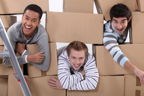 Organised office move process with labelled boxes and workspace items