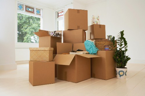 Boxes and furniture measured for cubic-yard pricing in an Ealing home